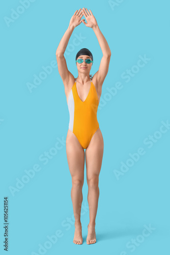 Young female swimmer on blu...