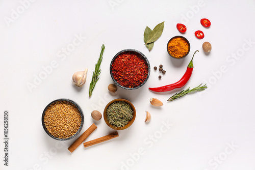 Fototapeta Naklejka Na Ścianę i Meble -  Different spoons and scoops with aromatic spices on grey background