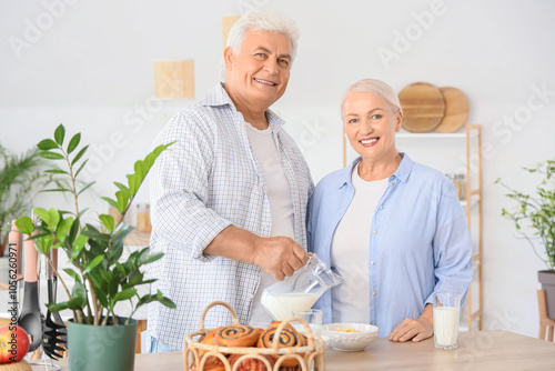 Happy senior couple adding ...