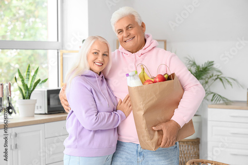 Happy senior couple holding...