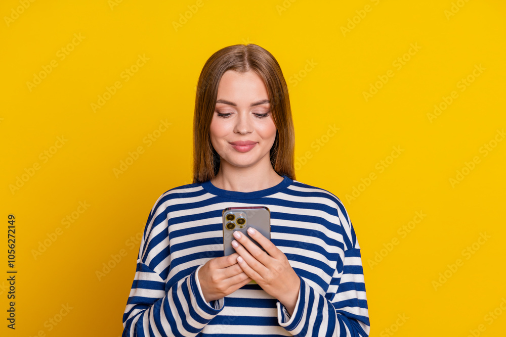Photo of adorable cute woman wear striped stylish clothes read post isolated on yellow color background Photo of adorable cute woman wear striped stylish clothes read post isolated on yellow color background