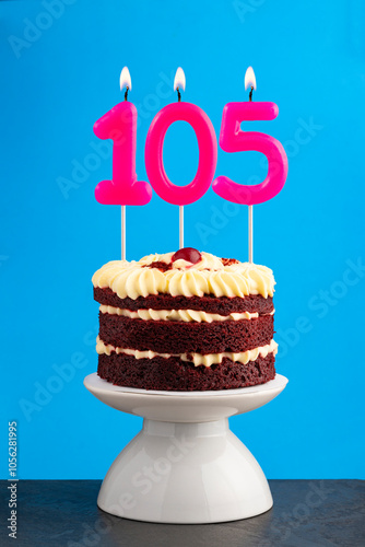 Red velvet birthday cake with number 105 candle