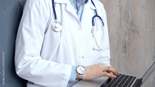 Doctor at work. Unrecognizable medical professional using laptop computer for healthcare research showcasing modern medical technology, close up