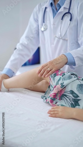 Doctor and kid patient. Orthopedist examining girl's knee in medical clinic. Medicine and health care photo