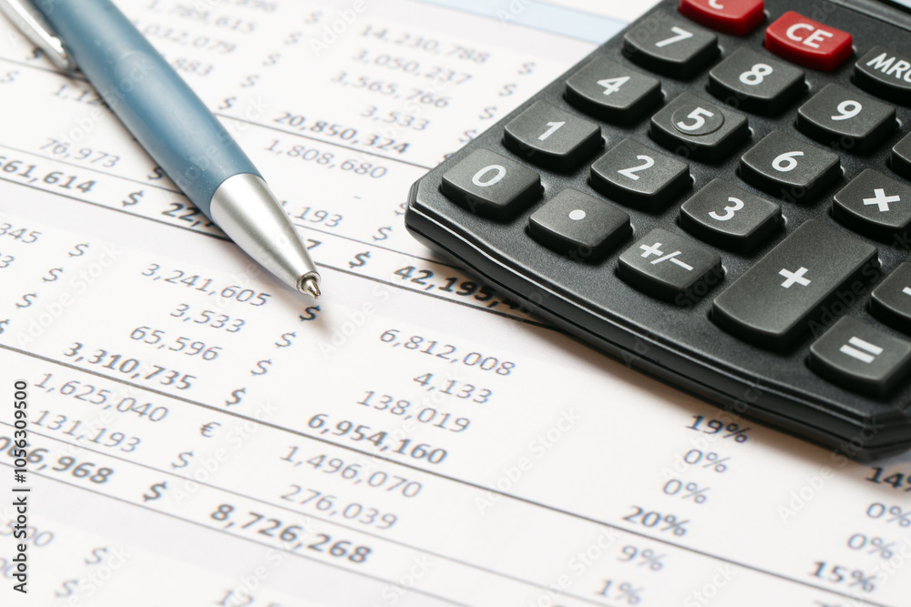 Financial statement or balance sheet summary report with calculator and pen Financial statement or balance sheet summary report with calculator and pen