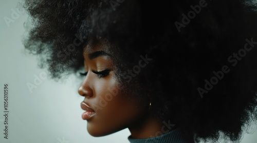 Young black woman shaking her afro hair, ideal for hair product ads.