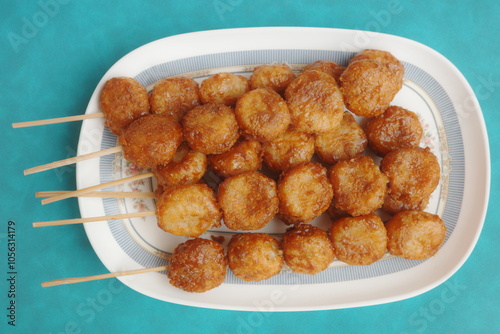 Bitso Bitso, a Filipino delicacy made with fried rice flour dough then coated with coconut cream and muscovado sugar syrup. photo