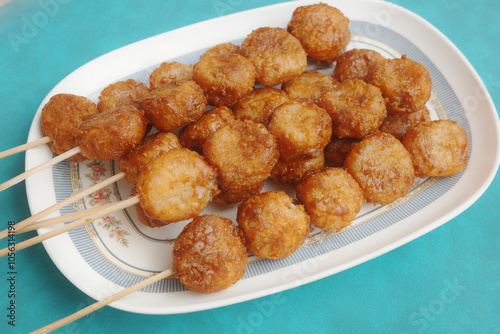 Bitso Bitso, a Filipino delicacy made with fried rice flour dough then coated with coconut cream and muscovado sugar syrup. photo