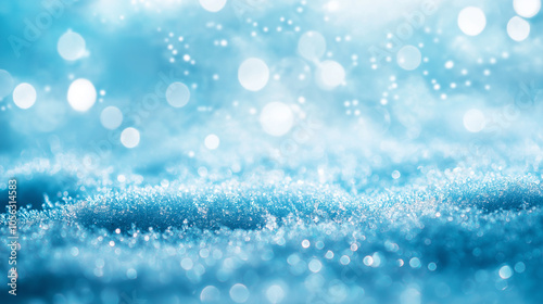 Background feature white bokeh effect, creating abstract Christmas scene, glistening blue, silver, and grey light add magical texture to festive atmosphere. Bling, blurred, bright, texture, winter.