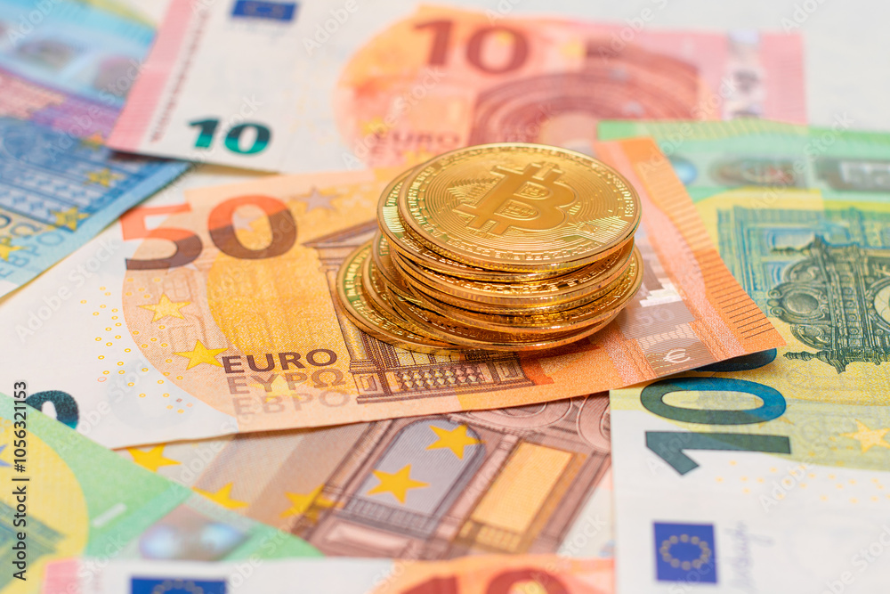 A Stack of Bitcoin Coins on the Euro Banknotes. Money Saving, Cryptocurrency, Blockchain and Anonymous Payments Concept A Stack of Bitcoin Coins on the Euro Banknotes. Money Saving, Cryptocurrency, Blockchain and Anonymous Payments Concept