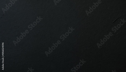 Close-up of heavy black paper with a slightly porous surface, showcasing its rich texture and warm undertones photo