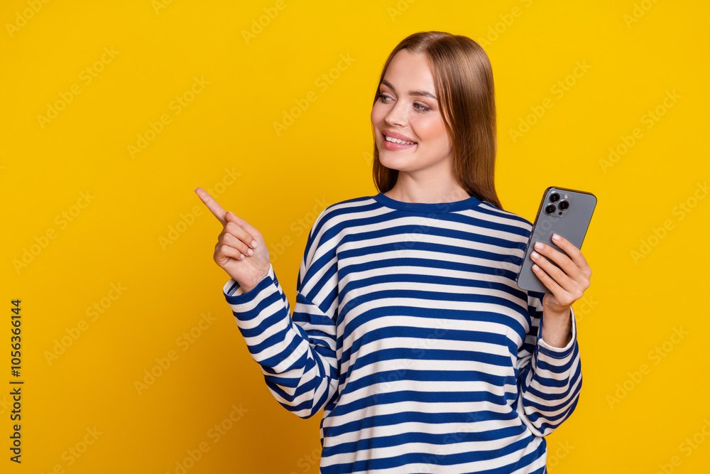 Photo of lovely cute woman wear striped stylish clothes presenting offer empty space isolated on yellow color background Photo of lovely cute woman wear striped stylish clothes presenting offer empty space isolated on yellow color background