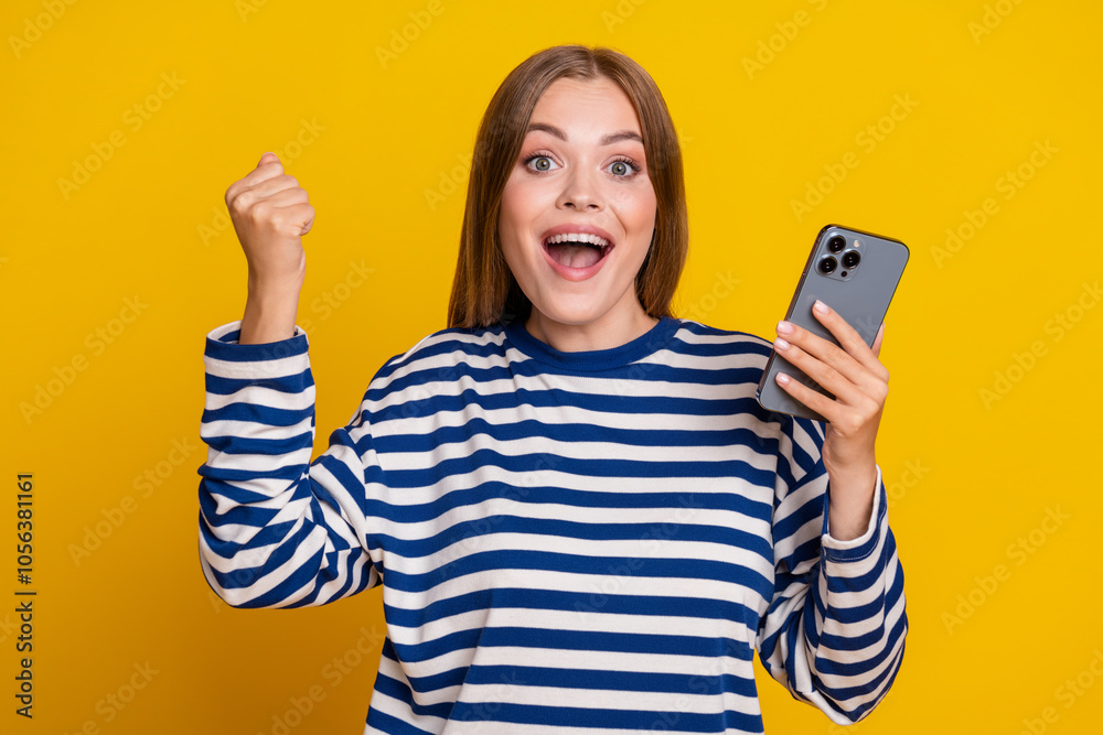 Photo of lovely cheerful glad woman wear striped stylish clothes isolated on yellow color background Photo of lovely cheerful glad woman wear striped stylish clothes isolated on yellow color background