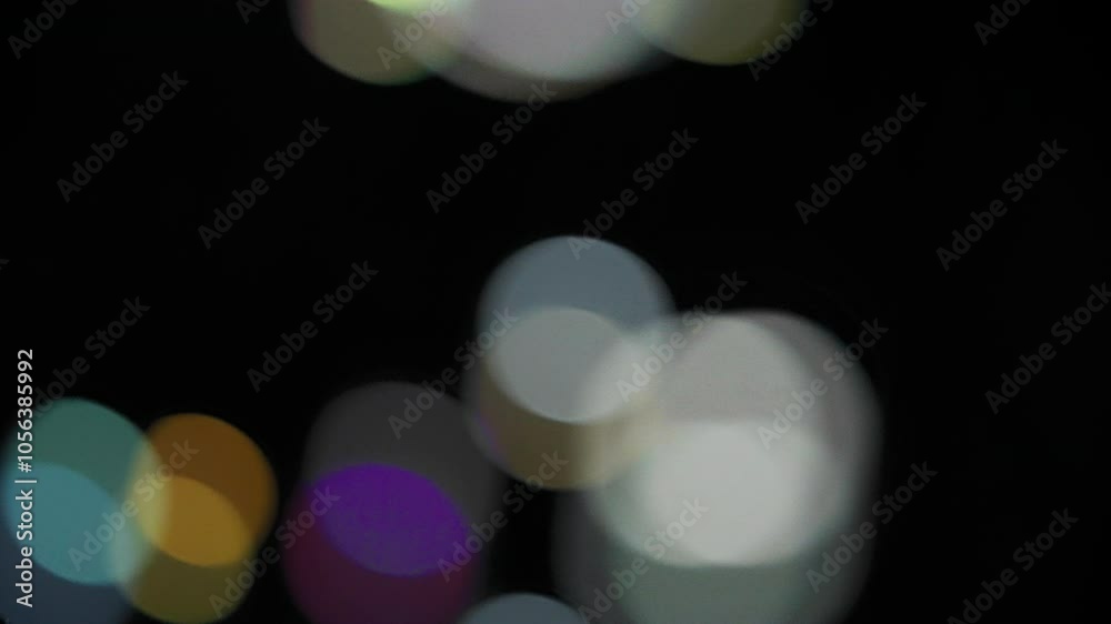 Abstract bokeh background of falling colorful soap bubbles. Slow motion. 