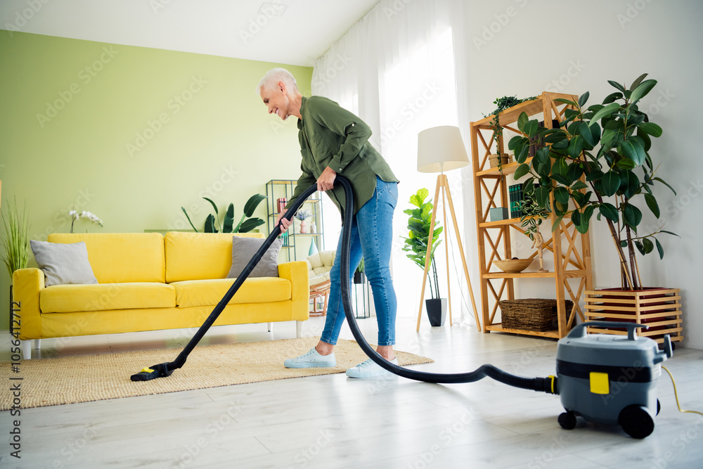Photo of adorable sweet lady wear khaki shirt enjoying vaccuum cleaner work indoors room home house Photo of adorable sweet lady wear khaki shirt enjoying vaccuum cleaner work indoors room home house