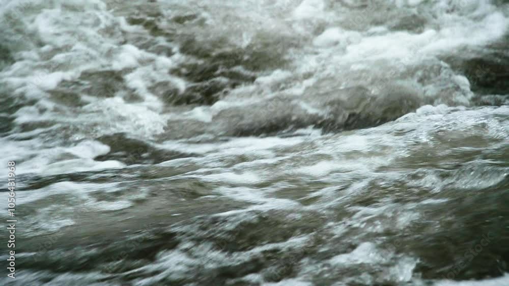 Slow motion closeup of bubbly whitewater flowing by Slow motion closeup of bubbly whitewater flowing by