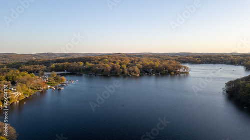 Εκτύπωση καμβά Tranquil sunset over a serene lake, capturing the peaceful reflections of fading sunlight on calm waters with silhouetted trees on the shoreline