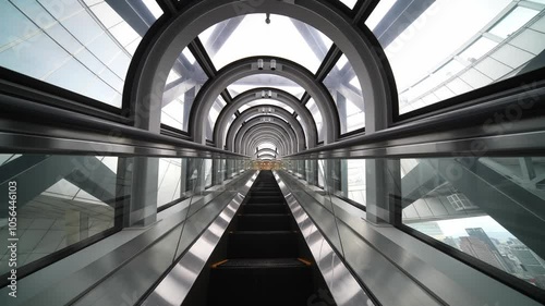 Futuristic tunnel escalator elevator on the move. Osaka city, Japan. Umeda Sky Building tourist attraction. Host city of Expo 2025. 