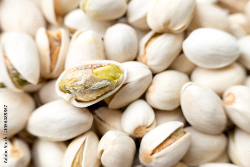 A detailed close-up view of several pistachio nuts in their shells, with some shells partially open, showcasing the nut inside. The intricate textures and natural appearance of the pistachios are high A detailed close-up view of several pistachio nuts in their shells, with some shells partially open, showcasing the nut inside. The intricate textures and natural appearance of the pistachios are high