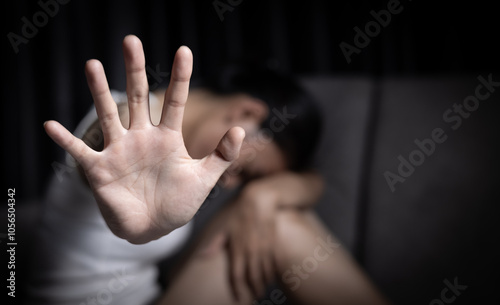 Close up of  woman showing stop gesture with hand blurred background. Stop violence against women. Intimidation and abuse of women.  Physical and psychological harassment.