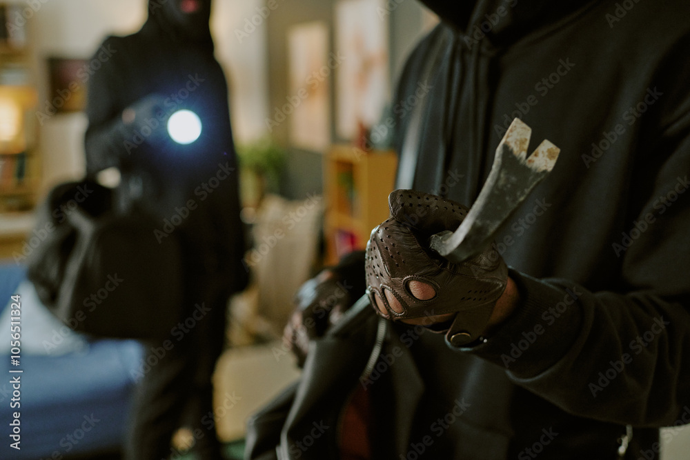 Medium close up of metal rusty crowbar in unrecognizable male hands with deep brown gloves Medium close up of metal rusty crowbar in unrecognizable male hands with deep brown gloves