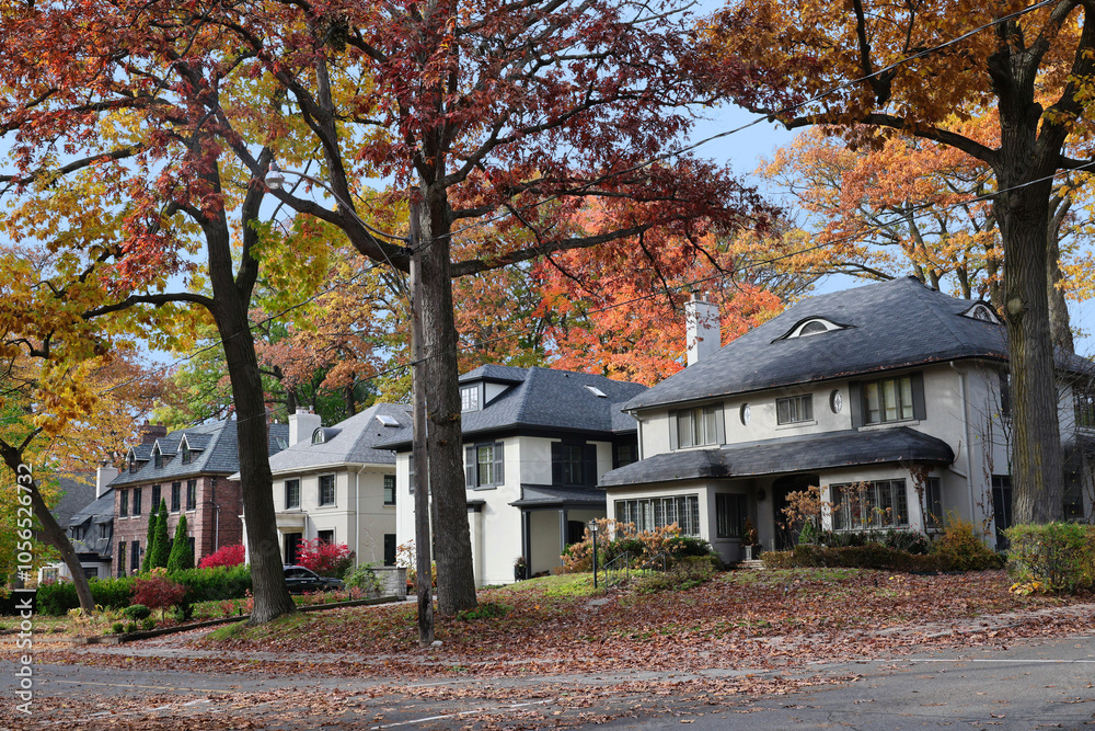 Residential street with large detached houses and fall foliage Residential street with large detached houses and fall foliage