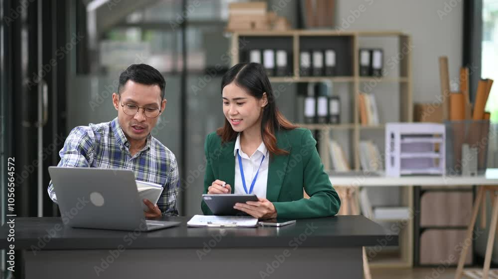 Two business workers talking on the smartphone and using laptop at the office. Two business workers talking on the smartphone and using laptop at the office.