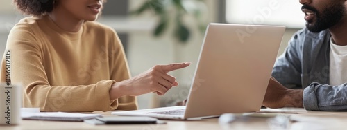 Two People Looking At a Laptop Screen