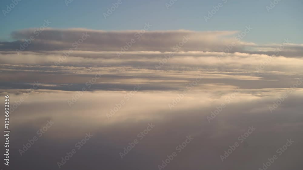 Captivating view of majestic clouds and vast sky during an early morning flight over the countryside with subtle sunlight illuminating the atmosphere Captivating view of majestic clouds and vast sky during an early morning flight over the countryside with subtle sunlight illuminating the atmosphere