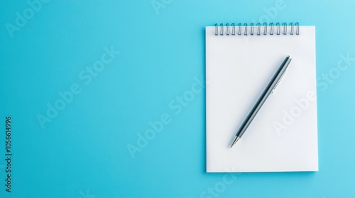 Blank paper representing goals with copy space for text a pen and a blue background symbolizes business planning and aspirations for the upcoming year