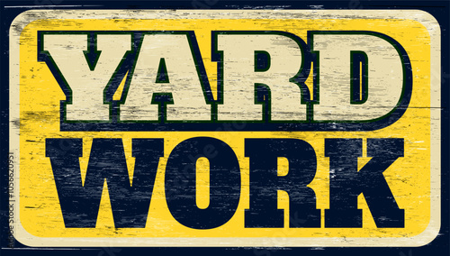 Aged and worn yard work sign on wood