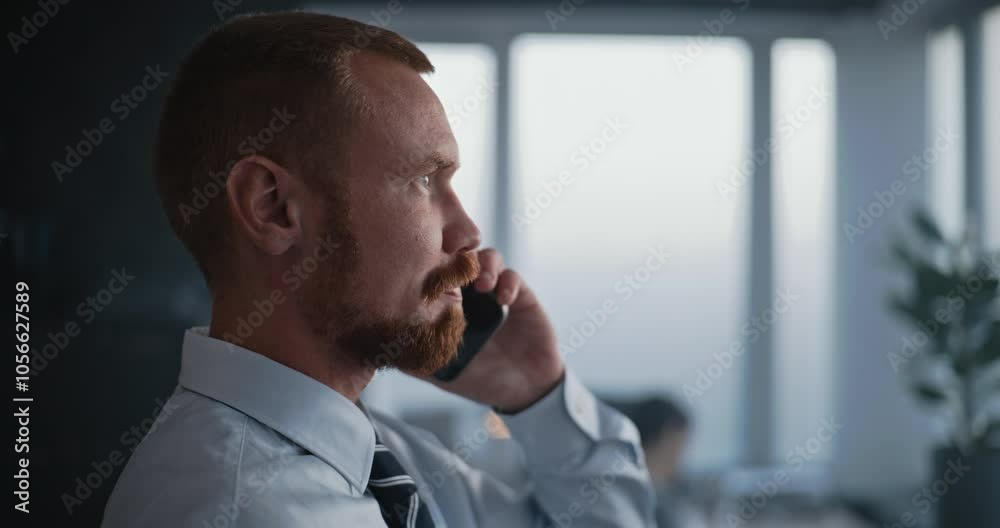 Close up of adult man working in modern corporate office: Professional financial specialist or banker communicates with business client by phone and discusses project, financial deal or investment. Close up of adult man working in modern corporate office: Professional financial specialist or banker communicates with business client by phone and discusses project, financial deal or investment.