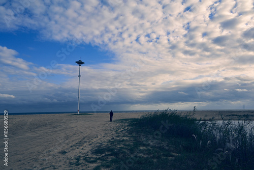 A lonely man walks on the beach, China, Shandong Province photo