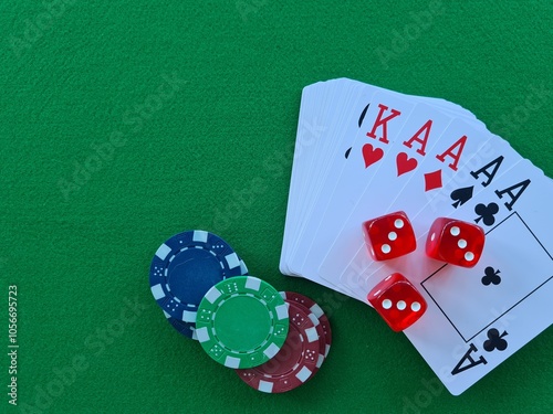 A winning hand of cards and dice on a vibrant green gaming table, perfect for a night of poker with friends photo