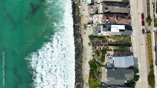 Captivating drone video of the waves and houses along the shore in Oceanside, California. USA photo