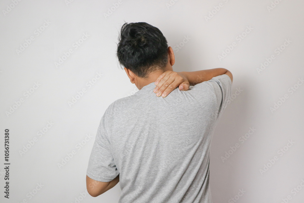 Asian young man having neck muscle pain,discomfort and strain in neck and shoulder,muscle tension,problem of bad pillow or poor posture,wrong sleeping position,health care concept Asian young man having neck muscle pain,discomfort and strain in neck and shoulder,muscle tension,problem of bad pillow or poor posture,wrong sleeping position,health care concept