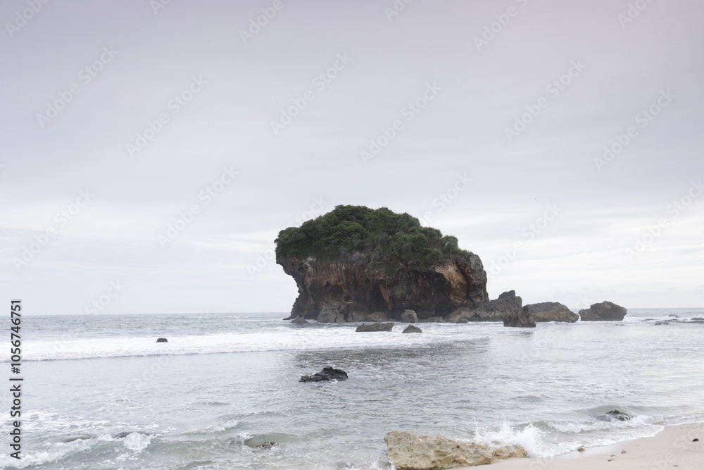 Fototapeta premium View of the ocean and large rocks with crashing ocean waves