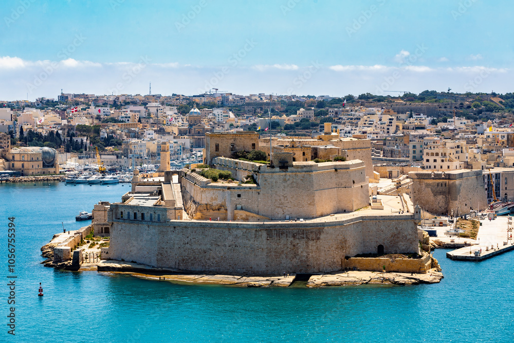 Fototapeta premium Fort St. Angelo, symbol of Malta's resilience, majestic stone walls, silent witness to rich history. Port in Birgu. View from Fort Saint Elmo. Cultural heritage of Malta