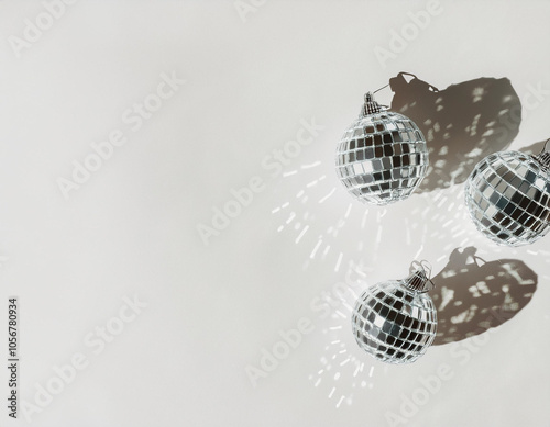 Shimmering disco balls with glittery sunlight shadows on white background