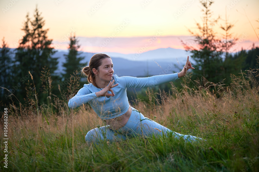 Woman practicing yoga outdoors in the mountains in a serene, natural setting. Female performing yoga pose, with backdrop of beautiful mountain landscape at sunrise or sunset. Woman practicing yoga outdoors in the mountains in a serene, natural setting. Female performing yoga pose, with backdrop of beautiful mountain landscape at sunrise or sunset.
