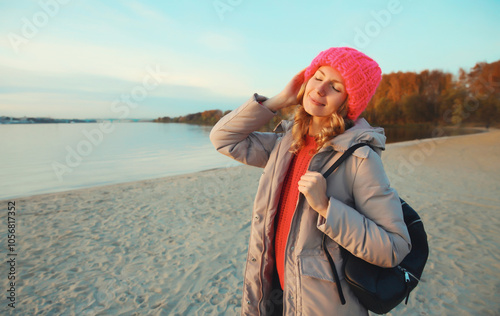 Travel, adventure, traveler woman on beach at sunset, enjoying landscape, on sea coast background