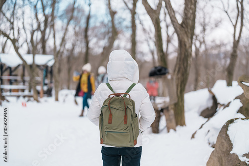 Woman tourist with Cute fox on snow in winter season at Zao fox village, traveler sightseeing Miyagi prefecture. landmark and popular for attraction near Sendai, Tohoku, Japan. Travel and Vacation photo