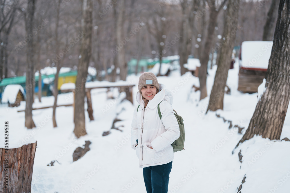 Obraz premium Woman tourist with Cute fox on snow in winter season at Zao fox village, traveler sightseeing Miyagi prefecture. landmark and popular for attraction near Sendai, Tohoku, Japan. Travel and Vacation