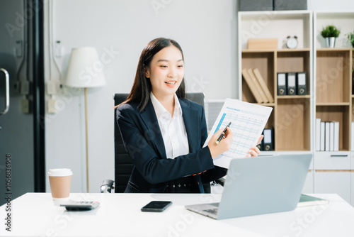 Business woman using tablet and laptop for doing math finance on an office desk,