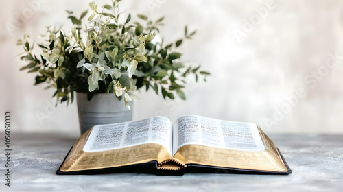 Open Bible with plant in background.