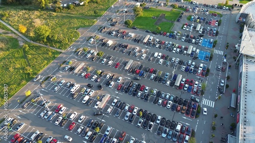 Parking lot beside shopping center seen from above