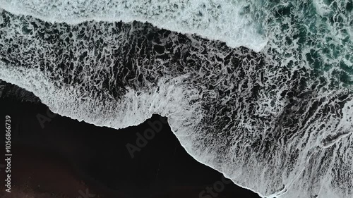 Bali black sand beach with huge waves at Pantai Purnama. Aerial cinematic 4k video. Beautiful Bali nature coastline from above. photo