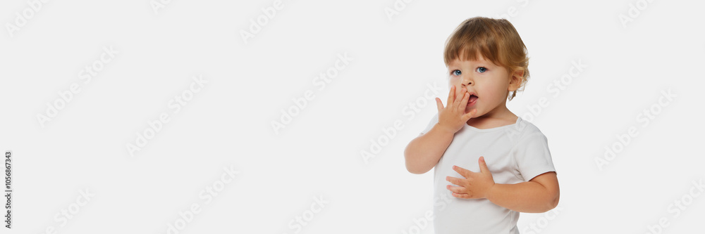 Banner. Cute baby in white onesie with surprised expression looking at camera against white studio background with negative space. Concept of parenthood, natural beauty, love and care. Ad. Banner. Cute baby in white onesie with surprised expression looking at camera against white studio background with negative space. Concept of parenthood, natural beauty, love and care. Ad.