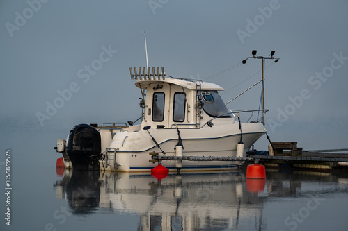 fishing boat a misty autumn morning Motala Sweden photo