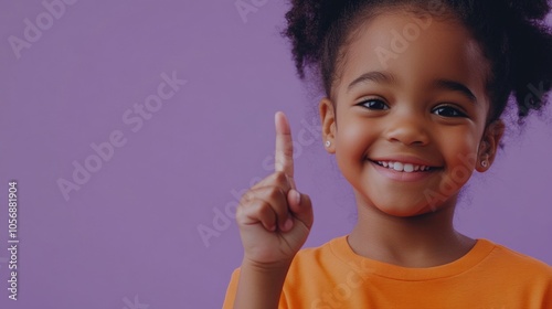 A young girl wearing an orange shirt gives a mischievous gesture, great for use in illustrations about childhood or everyday life